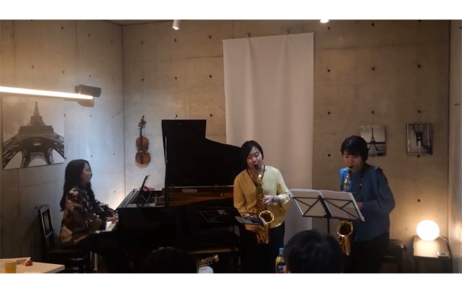 演奏中の様子。偶然にもこのカフェにはエッフェル塔など、パリにちなんだ写真が飾られており、ご縁を感じました。