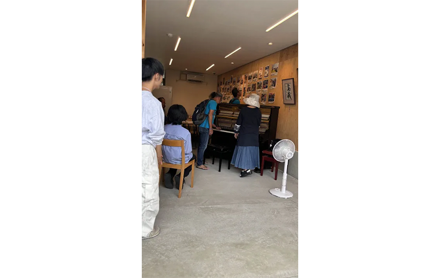 まちかどキャンパス『吹風舎』に設置したストリートピアノ、通行人が足を止めて聴く姿も